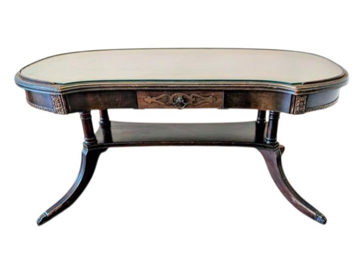 Elevate your space with this Theodore Alexander kidney-shaped cocktail table.